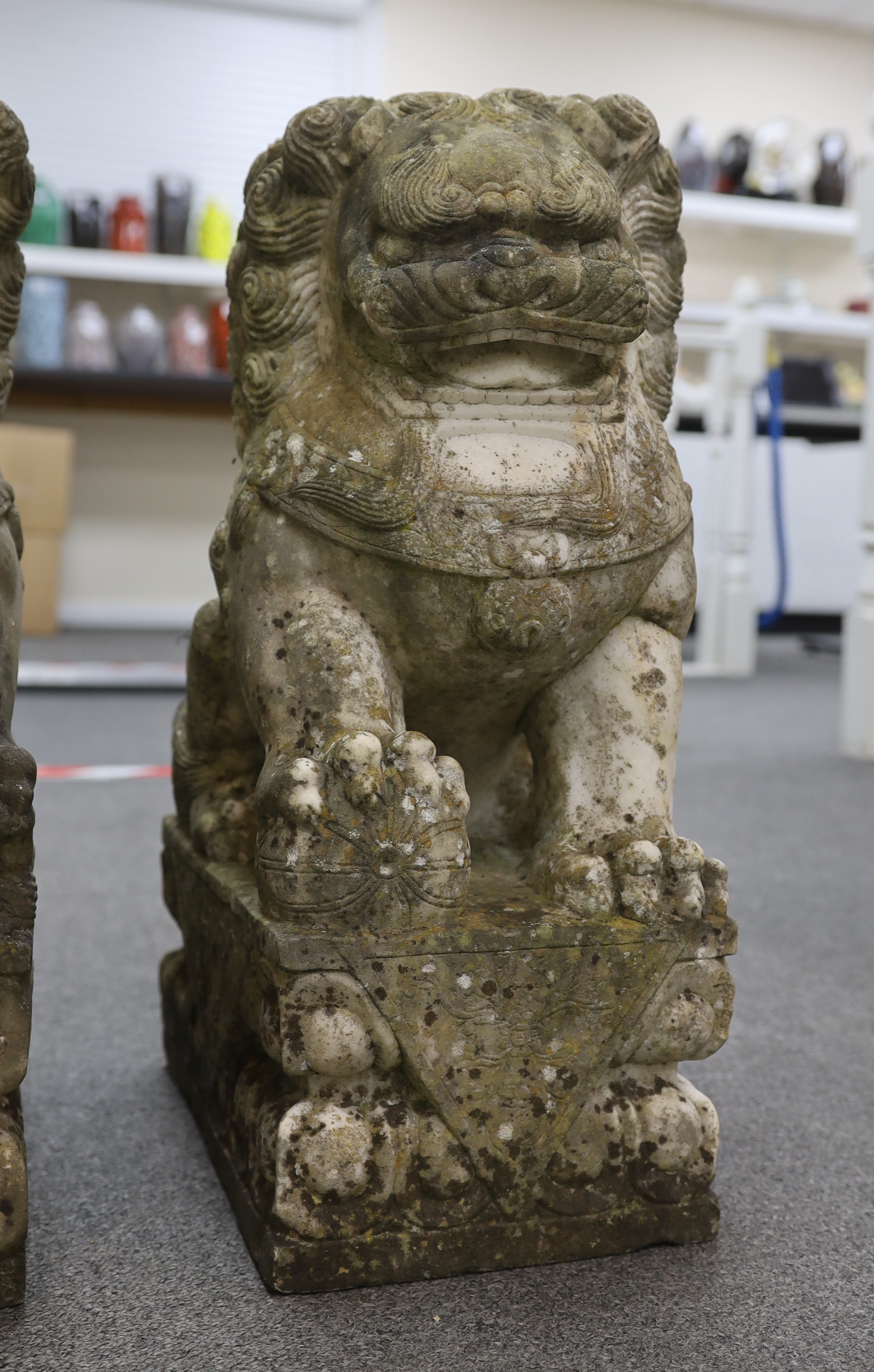 A pair of 20th century Chinese carved marble garden statues modelled as Dogs of Fo, each with weathered finish, 22cm wide, 31cm deep, 54cm high